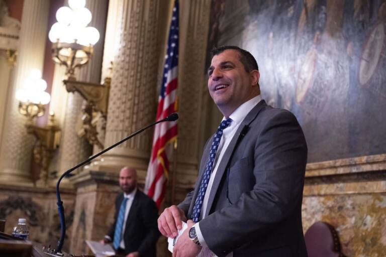 Mark Rozzi stands at a podium in the state legislature room.