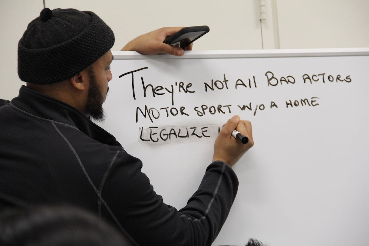 A person writes on a white board.