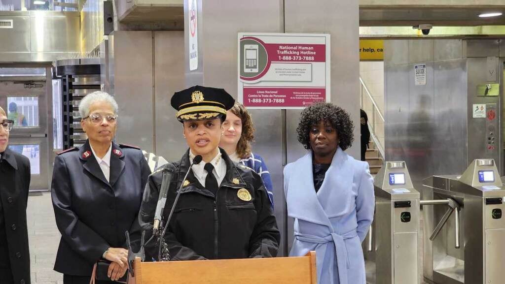 PPD Commissioner Danielle Outlaw speaks from a podium in a SEPTA station.