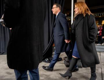 Shapiro walks hand in hand with his wife.