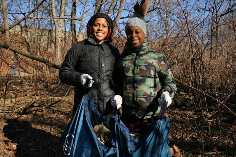 Shelley Henderson (left) and her daughter, Jaylynn Chalmers, 13, work together to clean up Tacony Creek Park