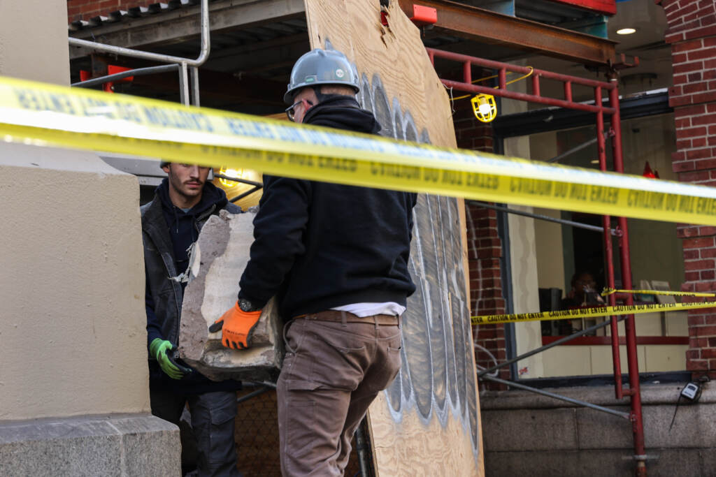 Construction workers moving debris