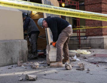 Construction workers moving debris