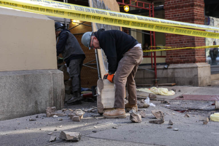 Construction workers moving debris