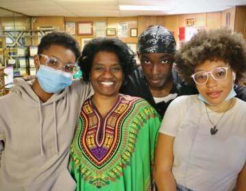 Jacqueline Taylor-Adams (center), development director for the House of Umoja and program director of the Youth Peace Corps, poses with three of her summer program students, (from left) Brielle Bartley, 16, Hameen Jackson, 15, and Jaelyn Mack, 14