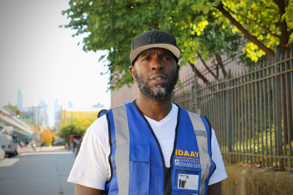 Malik Smith poses for a photo outside of a school