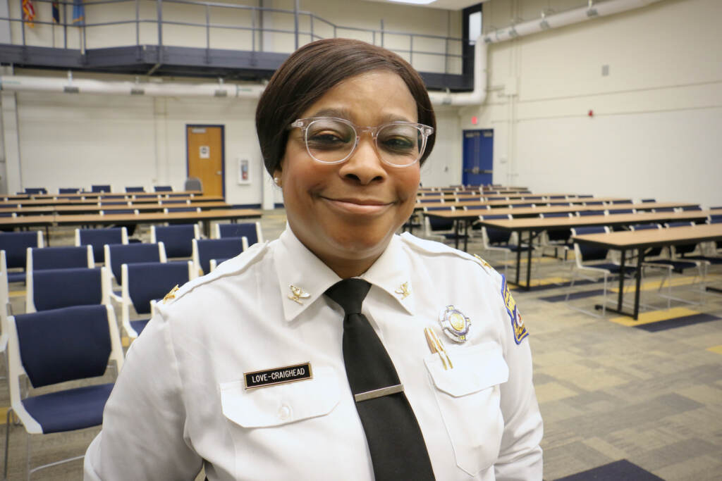 Altovise Love-Craighead smiles. An empty classroom is visible behind her.