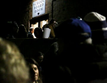 People line up to attend a Central Bucks School Board meeting In Doylestown, Pa. (Emma Lee/WHYY)