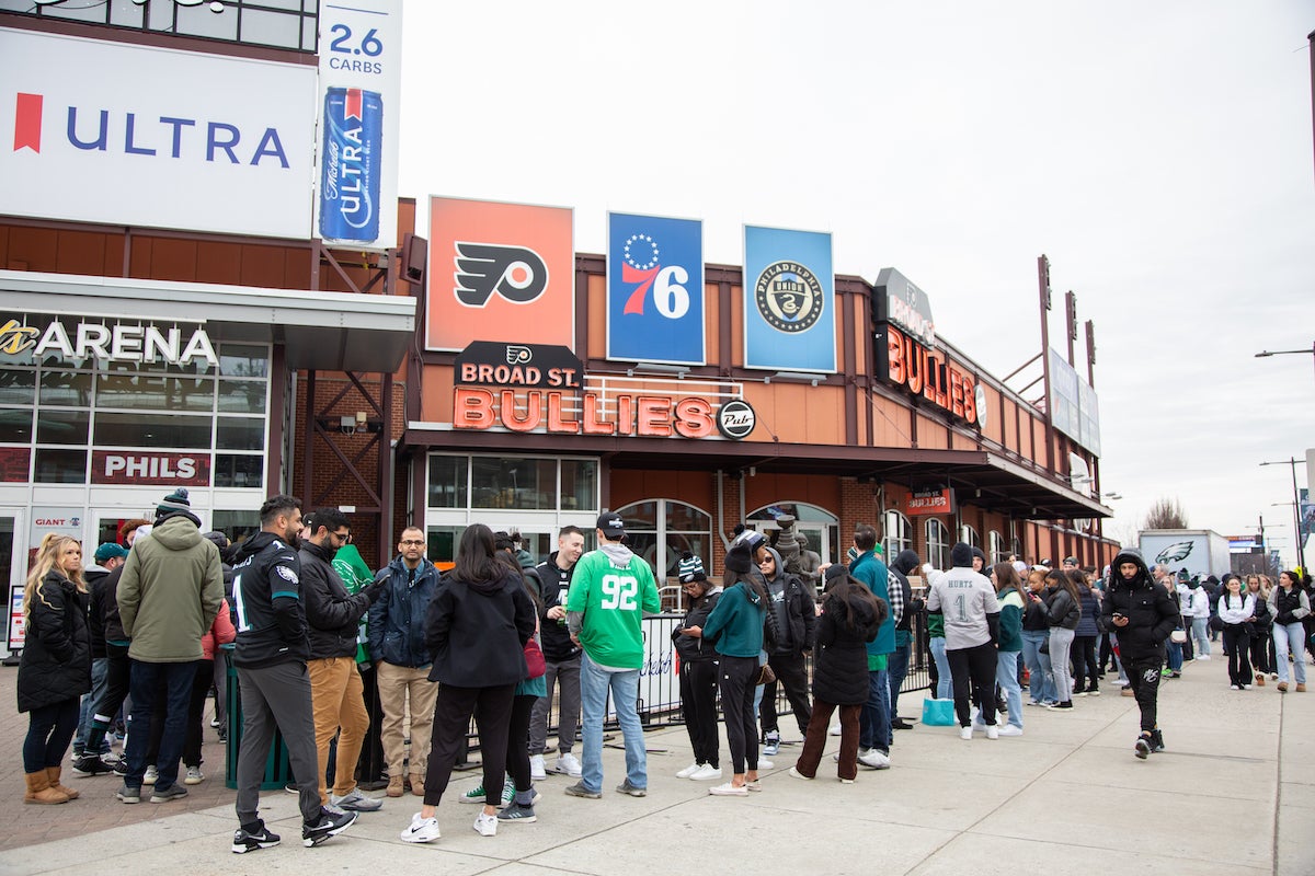 The line to get into Xfinity Live! stretched two blocks, hours before the doors opened with fans eager to get their celebrations started for Super Bowl LVII. (Emily Cohen for WHYY)