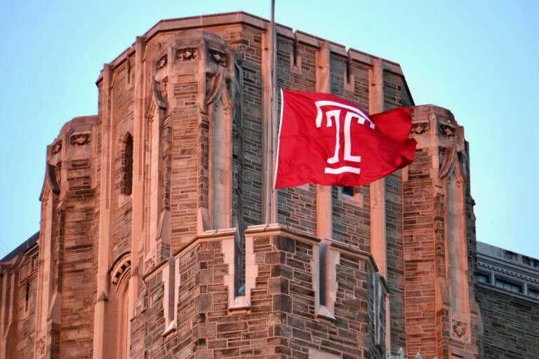 A flag bearing Temple University's logo flies at half-staff.