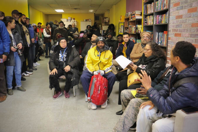 Anti-gun violence activists fill the room at Frontline Dads Teen Safe Space in North Philadelphia, where they pledged to work together and demanded $100 million from the city to support their work. (Emma Lee/WHYY)