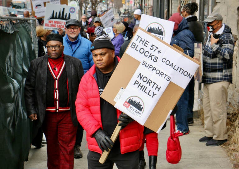 Rueben Jones of Frontline Dads leads a march against gun violence through the streets of North Philadelphia. (Emma Lee/WHYY)