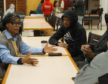 Kenyetta Overton, the director of the Murals of the Mind Project, talks to attendees