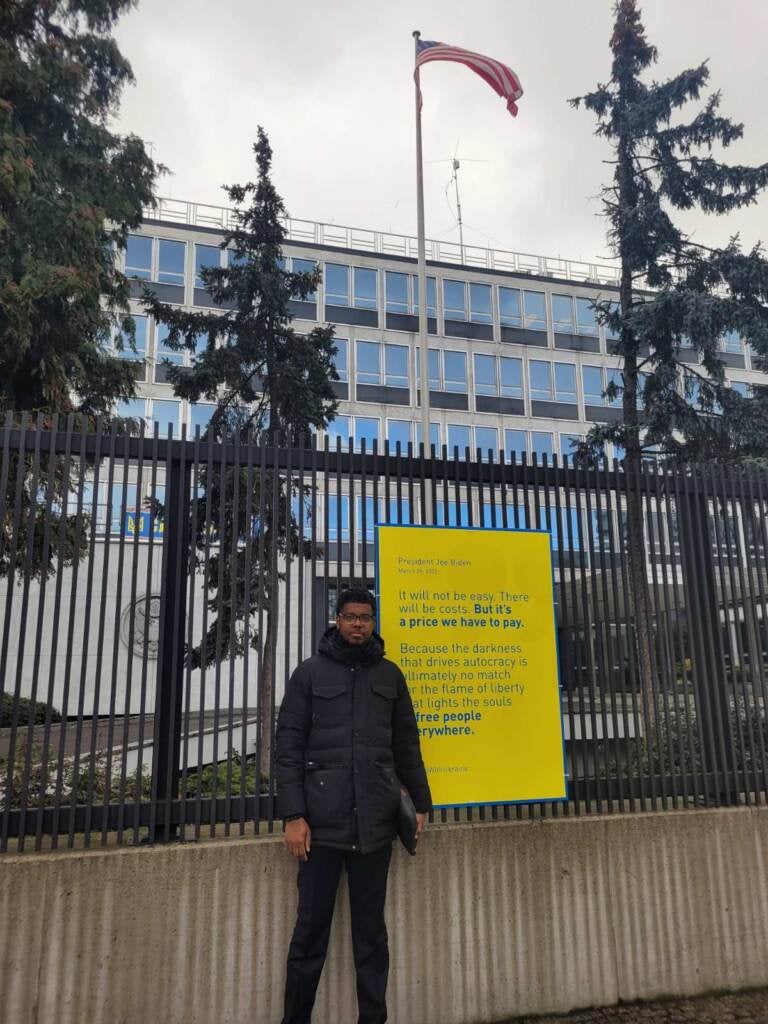 Alleyne stands outside Poland's Royal Palace before Biden's speech