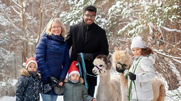 Tatiana Poladko and Atnre Alleyne pose with their family