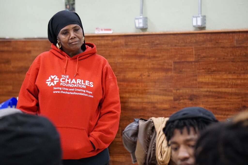 Movita Harrell listens to a question at the Youth Gun Violence Summit put on by her organization, The Charles Foundation