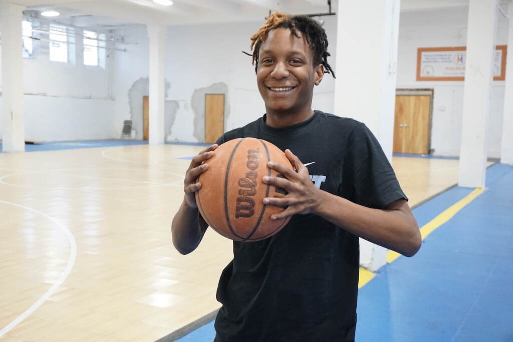Daniel Tyrell White holds a basketball