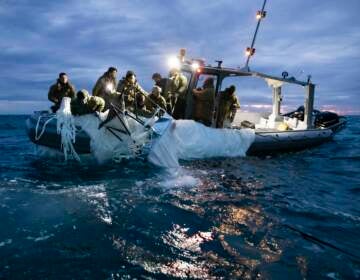 Sailors recover a high-altitude surveillance balloon in the waters off the coast of Myrtle Beach, S.C., on Feb. 5, after a fighter jet shot the balloon out of the sky. (Petty Officer 1st Class Tyler Thompson/U.S. Navy Photo)