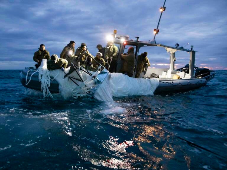 Sailors recover a high-altitude surveillance balloon in the waters off the coast of Myrtle Beach, S.C., on Feb. 5, after a fighter jet shot the balloon out of the sky. (Petty Officer 1st Class Tyler Thompson/U.S. Navy Photo)