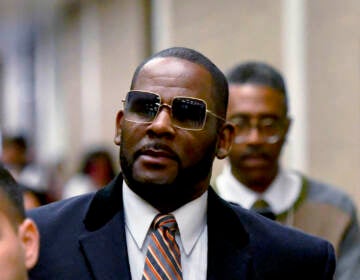 R. Kelly, center, leaves the Daley Center after a hearing in his child support case May 8, 2019, in Chicago