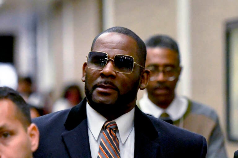 R. Kelly, center, leaves the Daley Center after a hearing in his child support case May 8, 2019, in Chicago