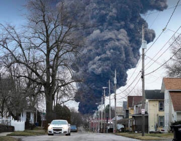 A black plume rises over East Palestine, Ohio, as a result of a controlled detonation of a portion of the derailed Norfolk Southern trains