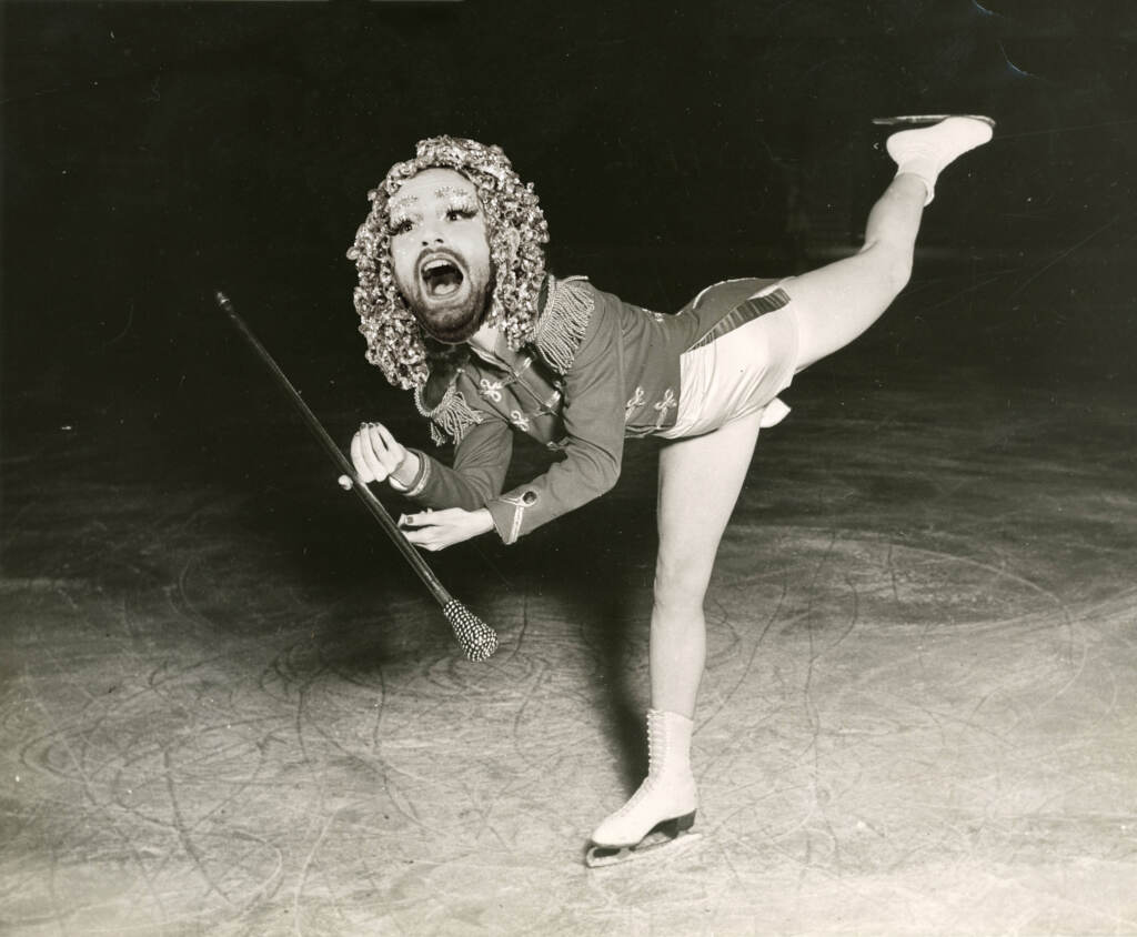 An ice-skater poses in a sepia-toned image