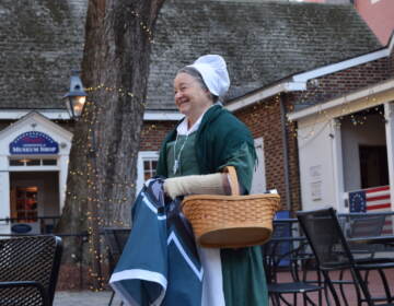 Betsy Ross impersonator Carol Spacht waiting to greet the Eagles fans before putting up the Eagles flag. (Ella Lathan/WHYY)