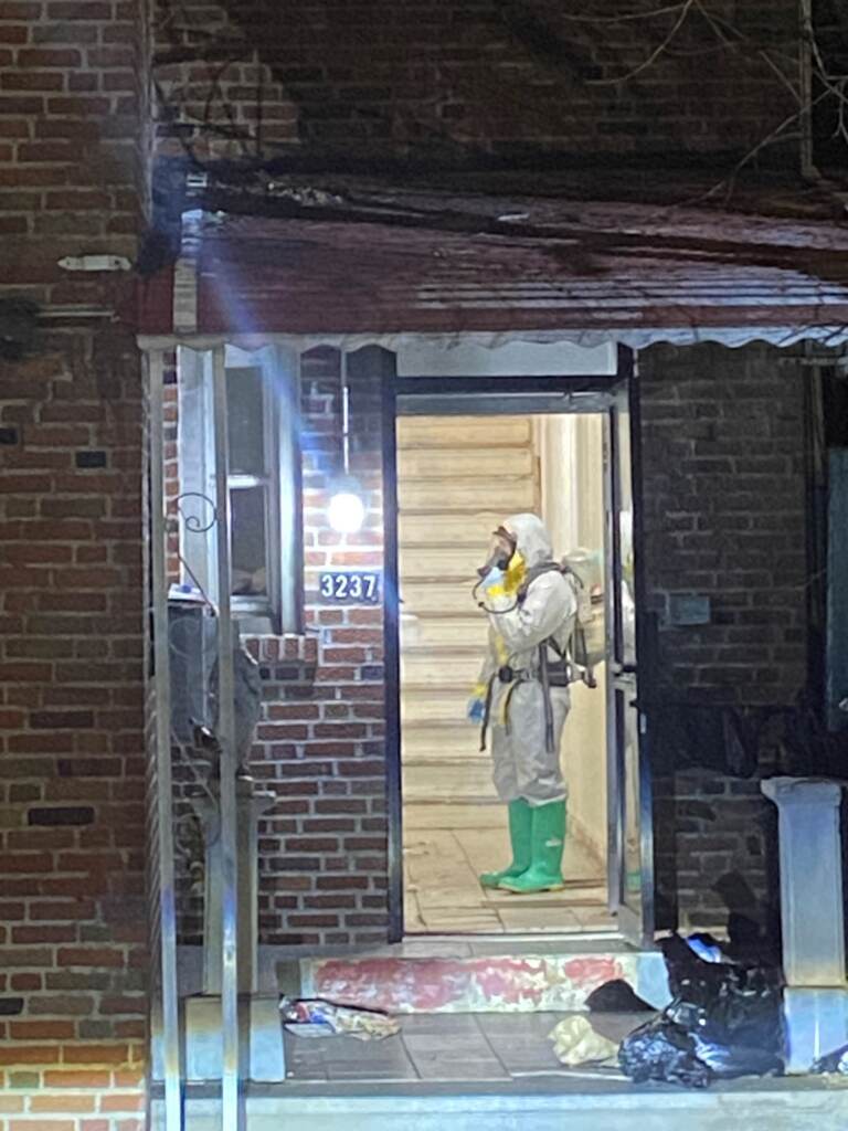 A member of the hazmat crew stands inside the Bronx home