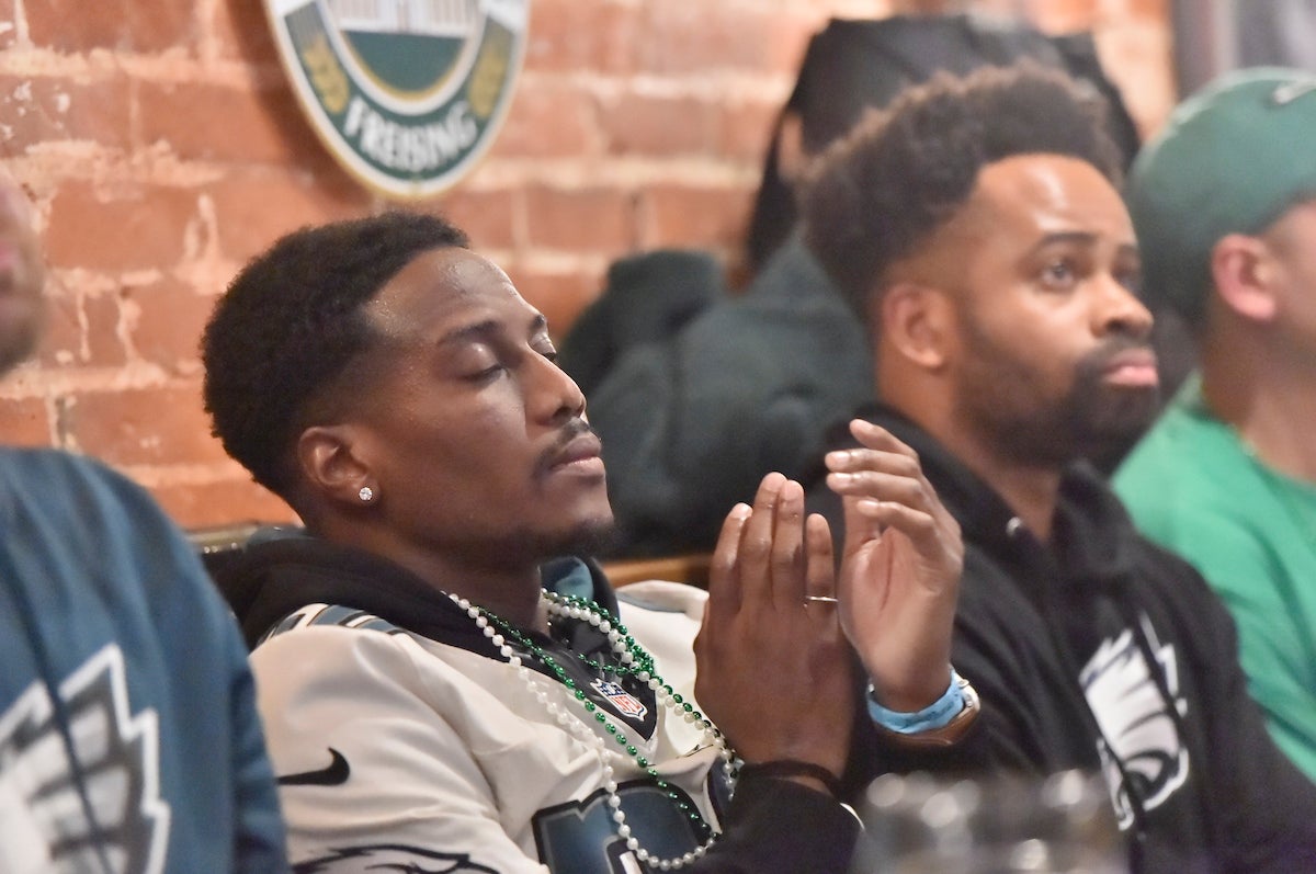 Eagles fans at Brauhaus Schmitz react after the team's Super Bowl LVII loss.(Jonathan Wilson for WHYY)