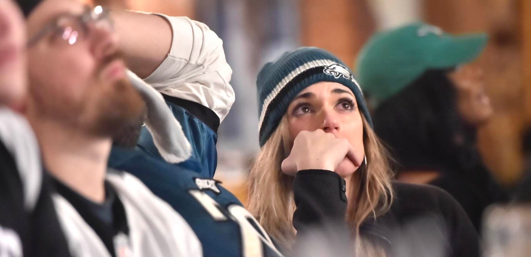 Eagles fans at Brauhaus Schmitz react after the team's Super Bowl LVII loss.(Jonathan Wilson for WHYY)