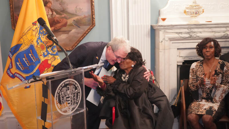 Murphy embraces Mildred Crump, the first Black woman elected to Newark's city council in 1994. (Tennyson Donyéa/WHYY)