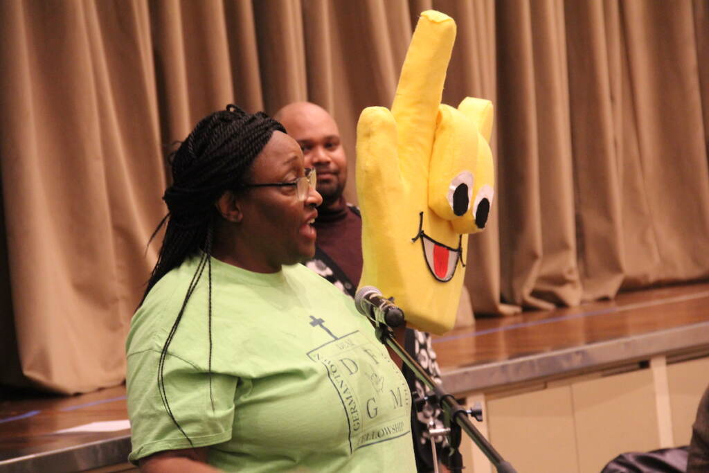 Roz McKelvey of Germantown Deaf Ministries told everyone "I Love You" in sign language during a community meeting at the Masjidullah Center for Human Excellence