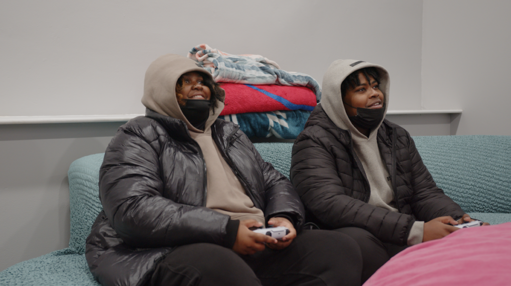 Kamorah (left) and Kahier (right) Myrick play video games in the lounging room at YEAH Philly