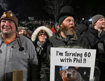 Rory Szwed, left, and Kent Rowan watch the festivities while waiting for Punxsutawney Phil to make his prediction at Gobbler's Knob in Punxsutawney, Pa., early Thursday morning. (Barry Reeger/AP)