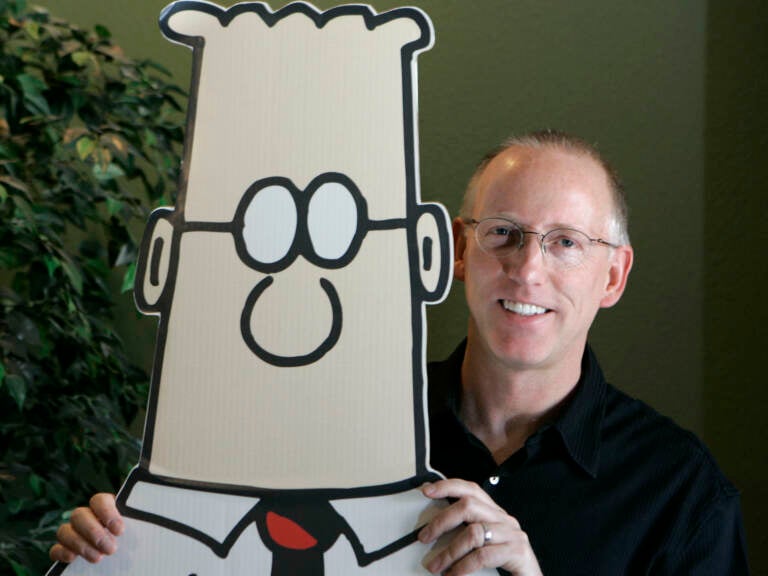 Scott Adams, creator of the comic strip ''Dilbert,'' poses for a portrait with the Dilbert character in his studio in Dublin, Calif., in 2006.