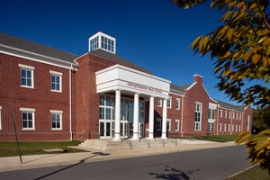 An exterior of a red-brick building on a sunny day