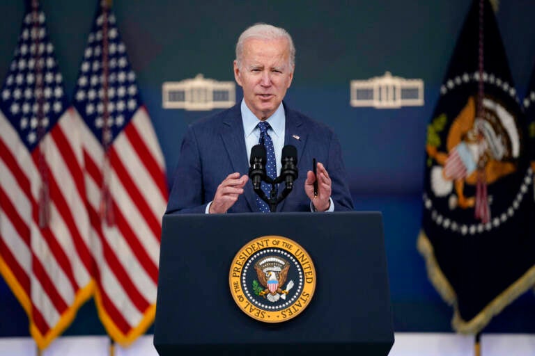 Biden speaks from a podium.