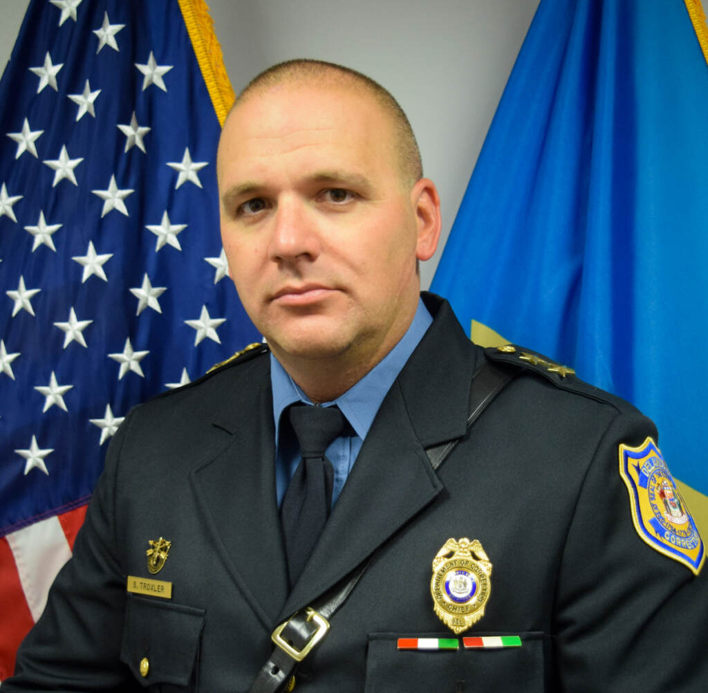 A man in uniform poses for a photo. 