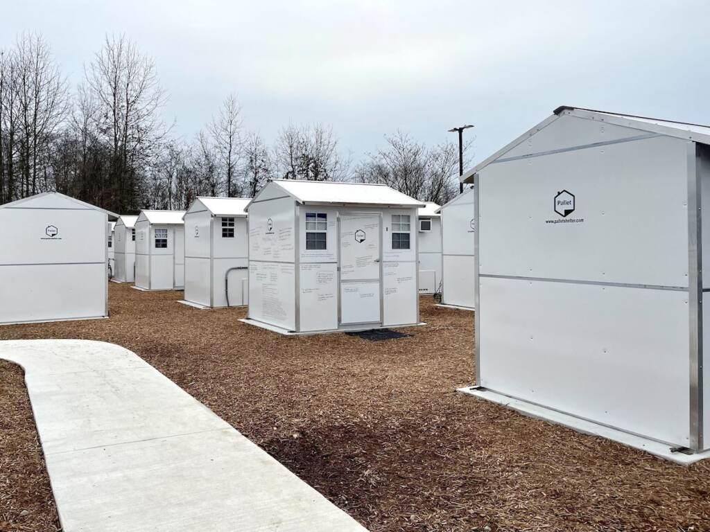 Several small white houses are arranged in rows.