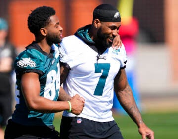 Two Eagles players walking on the field