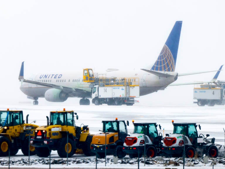 A United Airlines flight is de-iced before takeoff during a winter storm at Denver International Airport on Wednesday in Denve