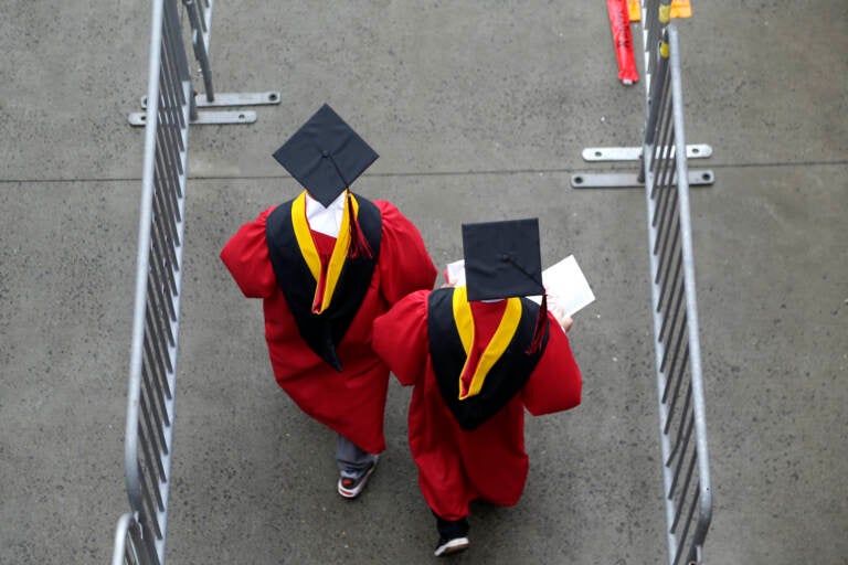 FILE - New graduates walk into the High Point Solutions Stadium before the start of the Rutgers University graduation ceremony in Piscataway Township, N.J., on May 13, 2018. The Supreme Court is about to hear arguments over President Joe Biden’s student debt relief plan. It's a plan that impacts millions of borrowers who could see their loans wiped away or reduced. (AP Photo/Seth Wenig, File)