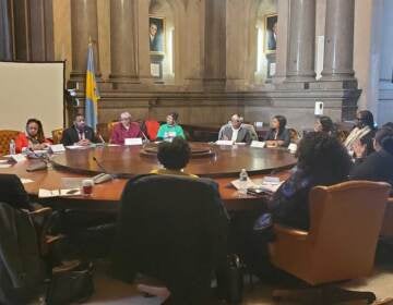 People sit around a large roundtable.