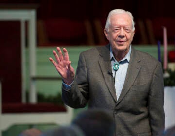 Jimmy Carter waves.