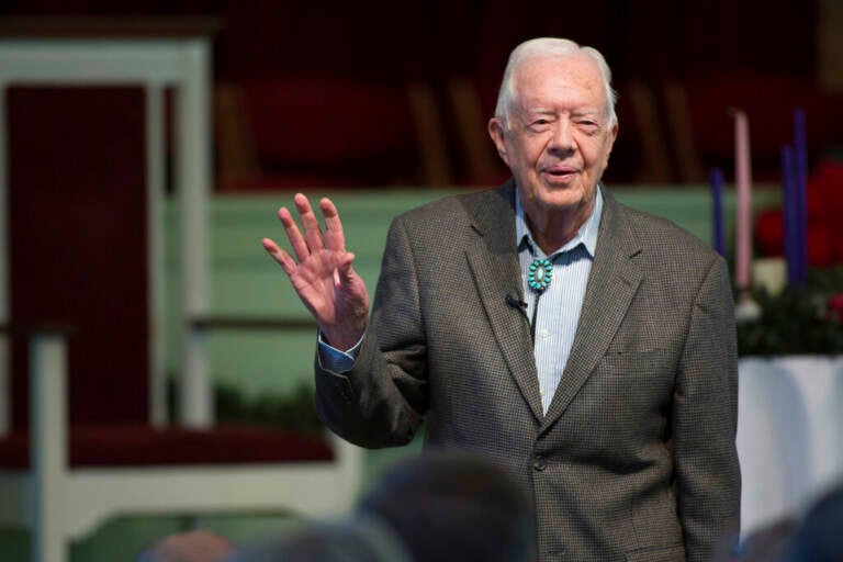 Jimmy Carter waves.