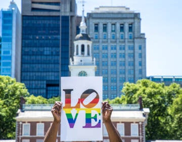 LGBTQ LOVE sign held up outside of Independence Hall