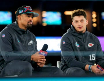 Jalen Hurts and Patrick Mahomes sitting together for a press event ahead of the Super Bowl