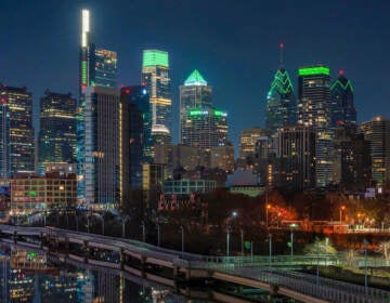 A view of Philly skyline lit up in green.