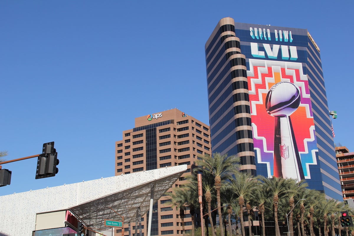 A large banner on the side of a building reads 